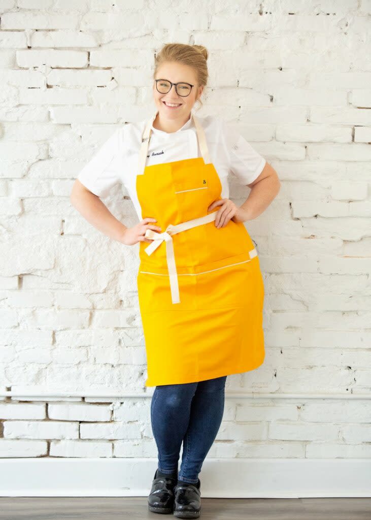 Owner of Bottom Line Bakery in yellow apron
