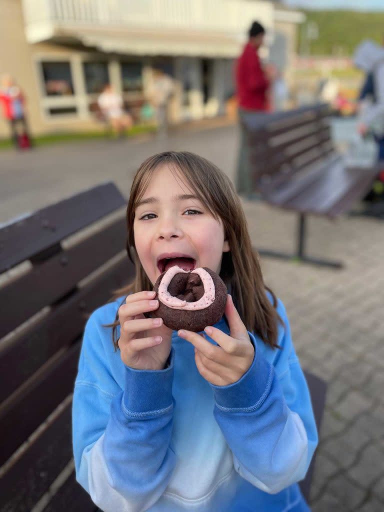 Young girl eating donut at Jamsen's in Copper Harbor