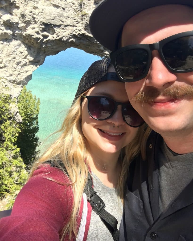 Couple Posing by Arch Rock for Selfie on Mackinac Island
