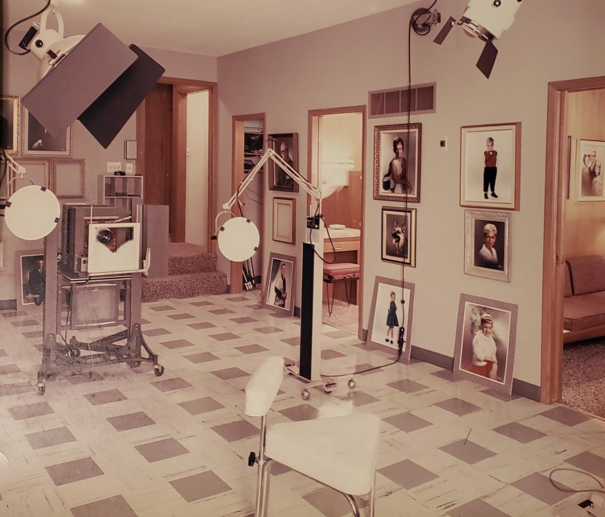 Portraits are hung on walls in an art exhibit