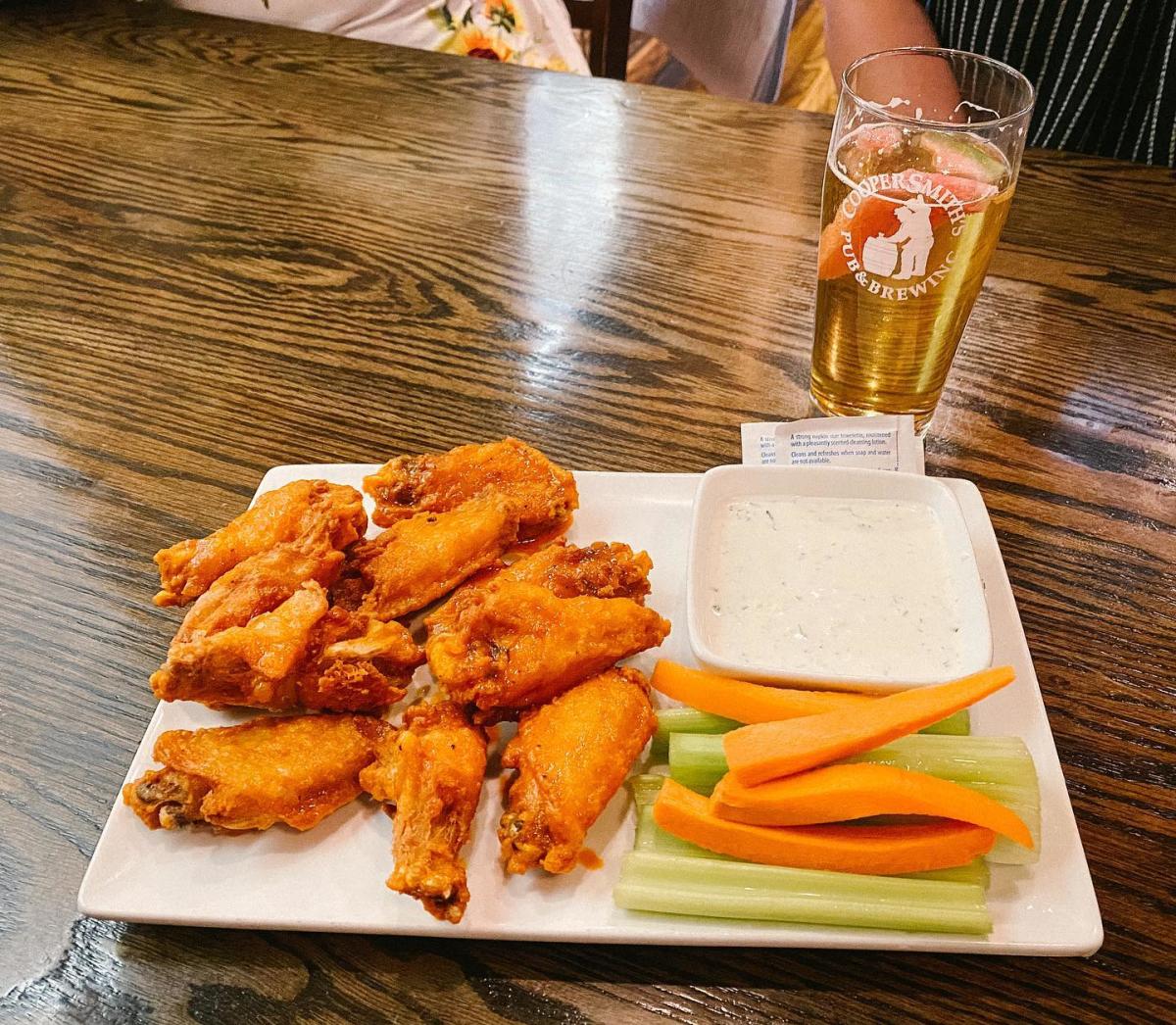 a plate of wings and celery and carrot stickst at CooperSmith's