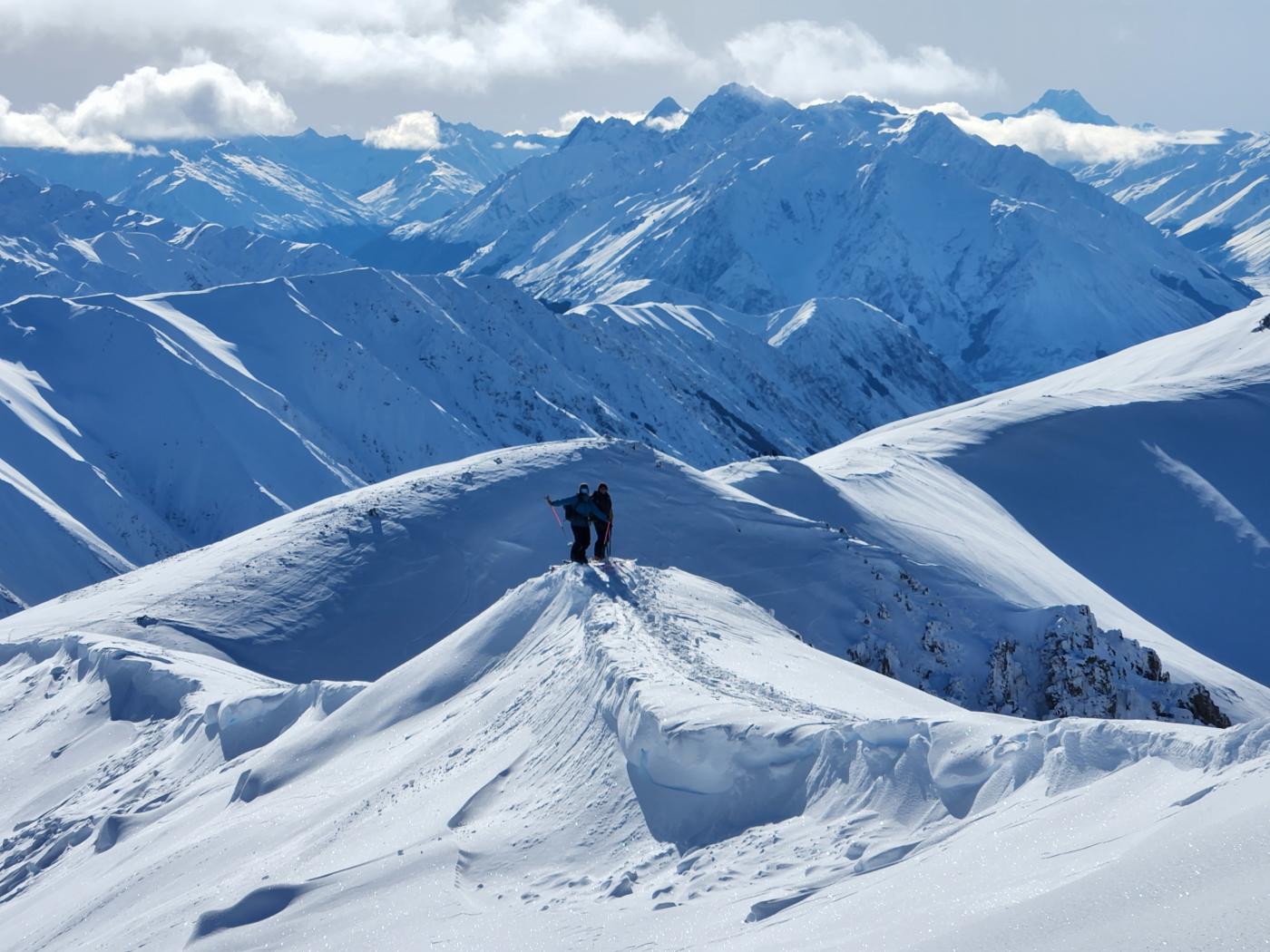 Two people backcountry skiing