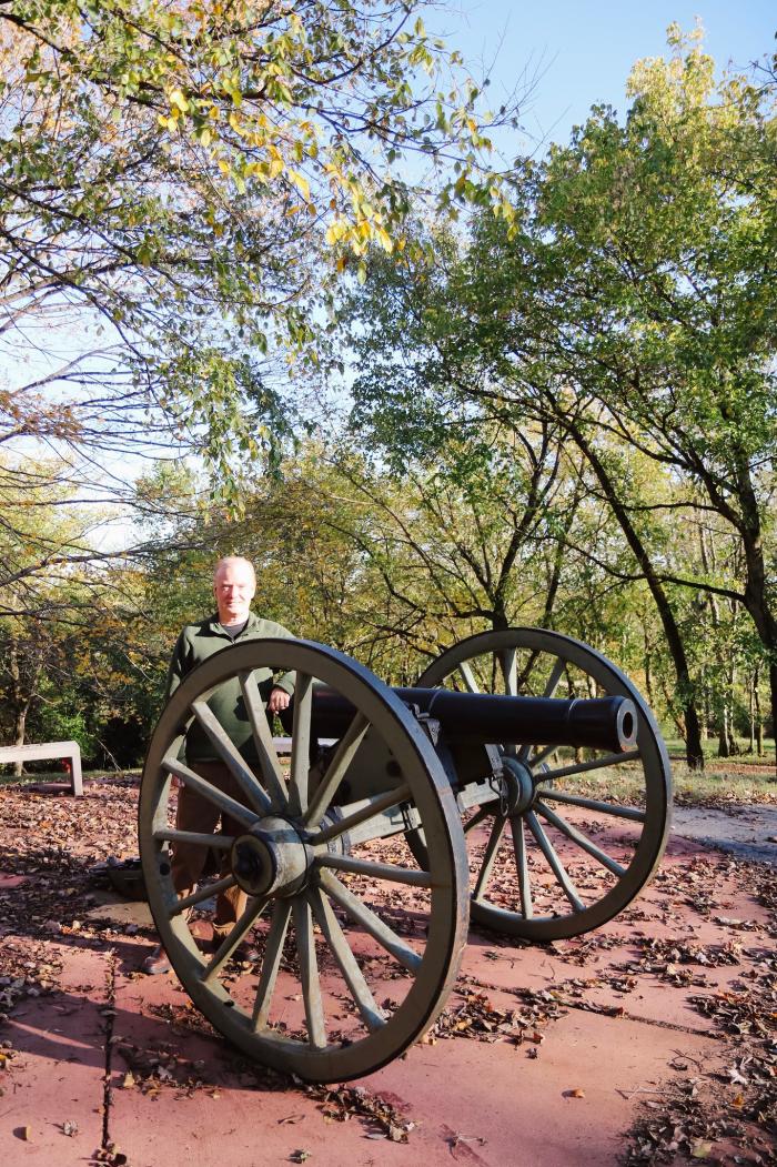 tour guide standing by cannon