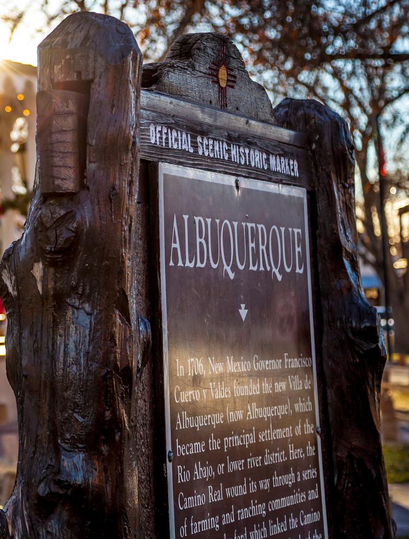 An image of the historic marker sign explaining Albuquerque's name in Old Town