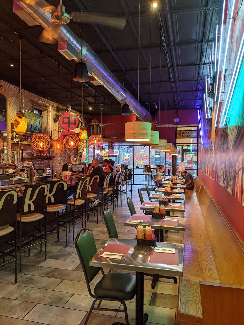 Row of chairs marked K at the counter of the colorful interior of Amerasia in Covington, Ky.