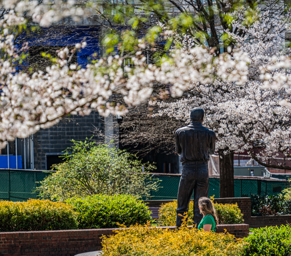 Photo of statue with spring blooms
