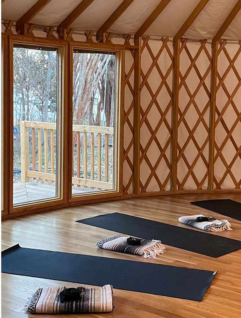 yoga mats are unrolled on the floor of the wellness yurt at Los Poblanos Historic Inn and Farm