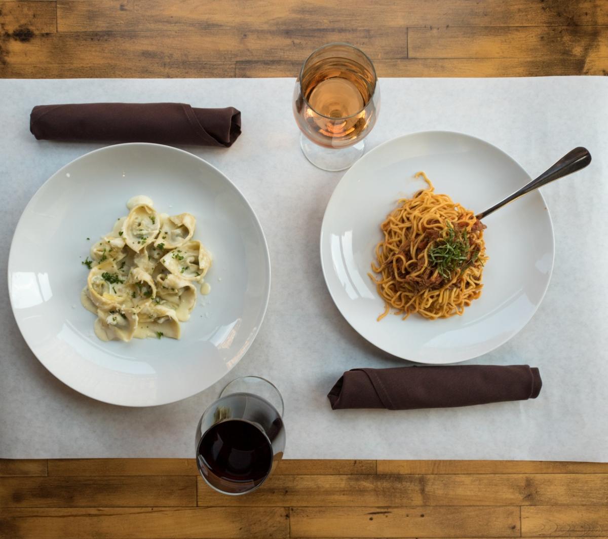 View of pasta dishes and wine from Onesto