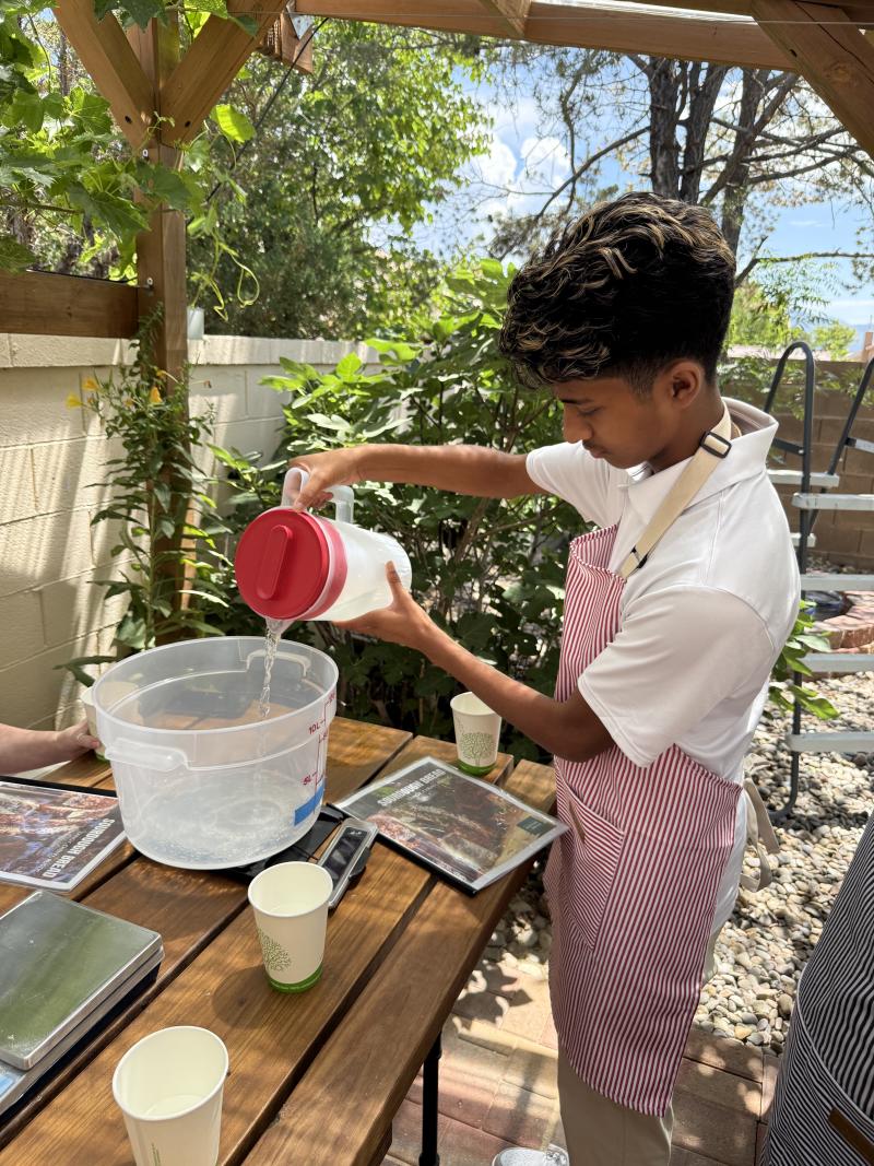 Nithin measures water to make dough at Sherwood Coffee n Bread.