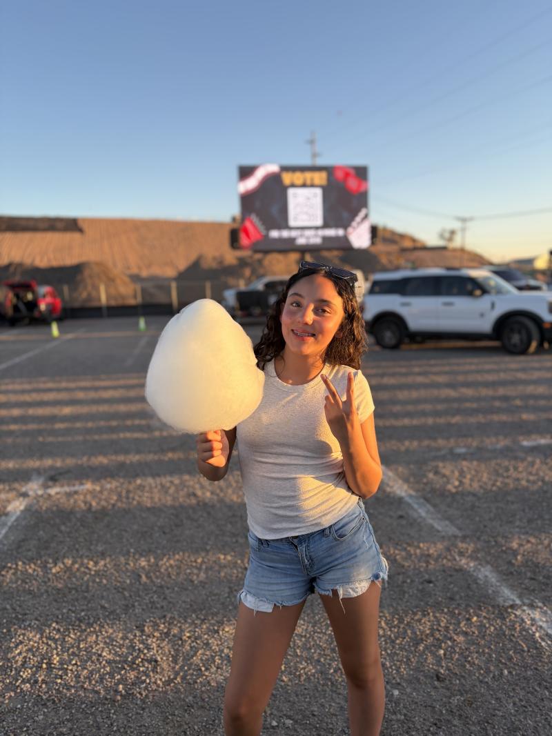 A youth attendee poses with cotton candy from one of the onsite food trucks.