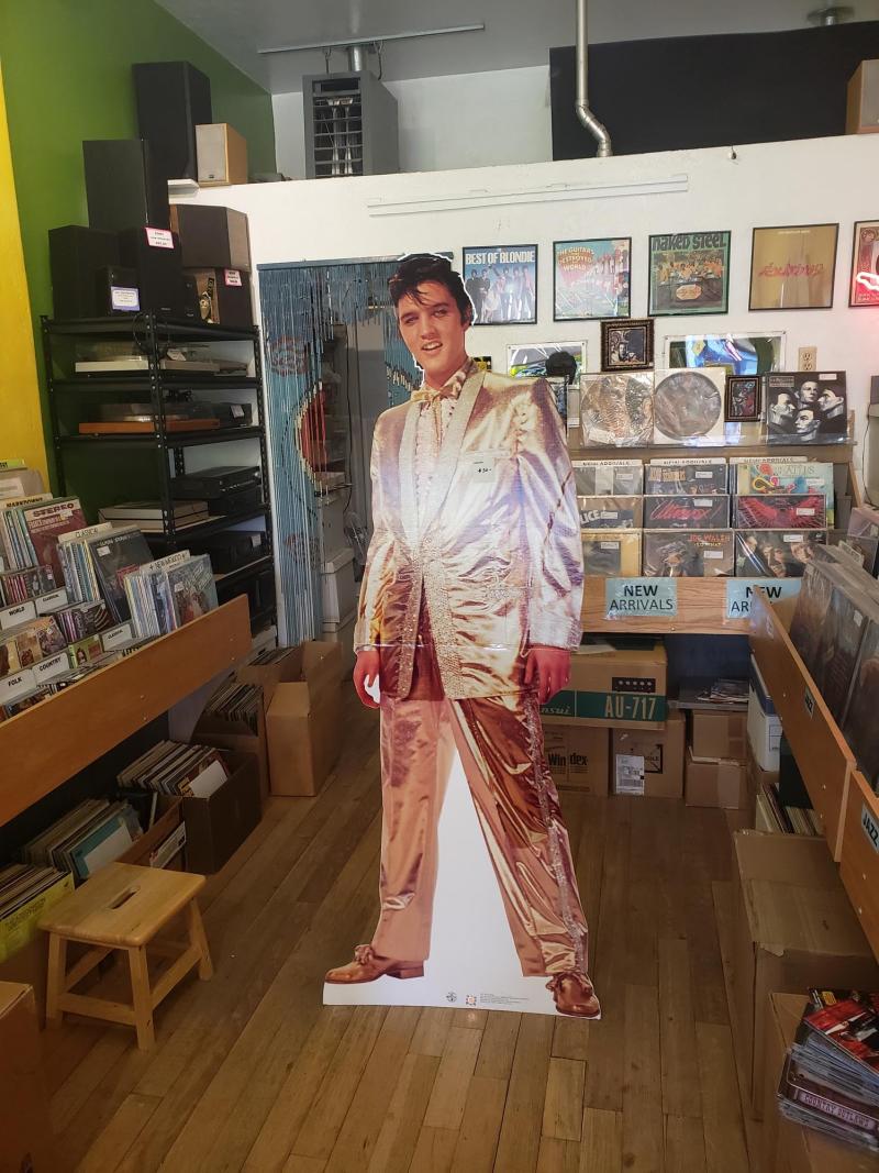 A cardboard cutout of Elvis stands in the middle of Nob Hill Music
