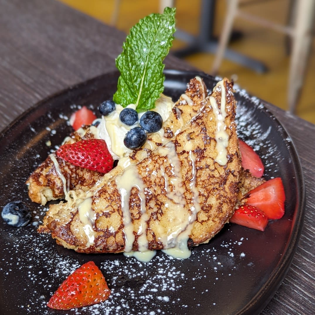 Image is of the Creme De La Creme (French toast) with a Chantilly cream and strawberries.