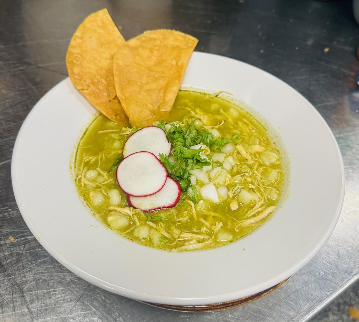 A bowl of soup is served with tortilla chips at Itzcali Tapas & Tequila
