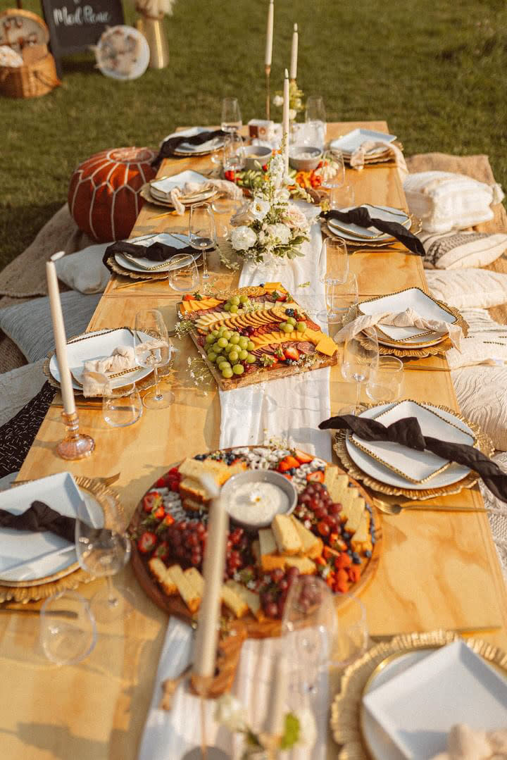 A spread of charcuterie on a low picnic table outside