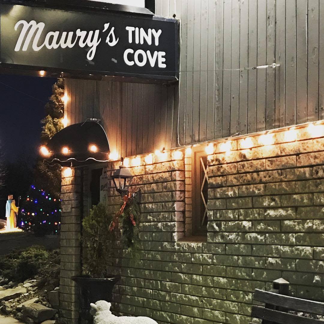 Image of the outside front door of Maury's Tiney Cove with the sign above the door that says "Maury's Tiny Cove".
