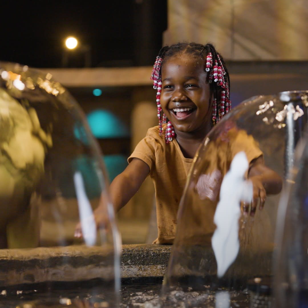 Young girl playing with interactive exhibit