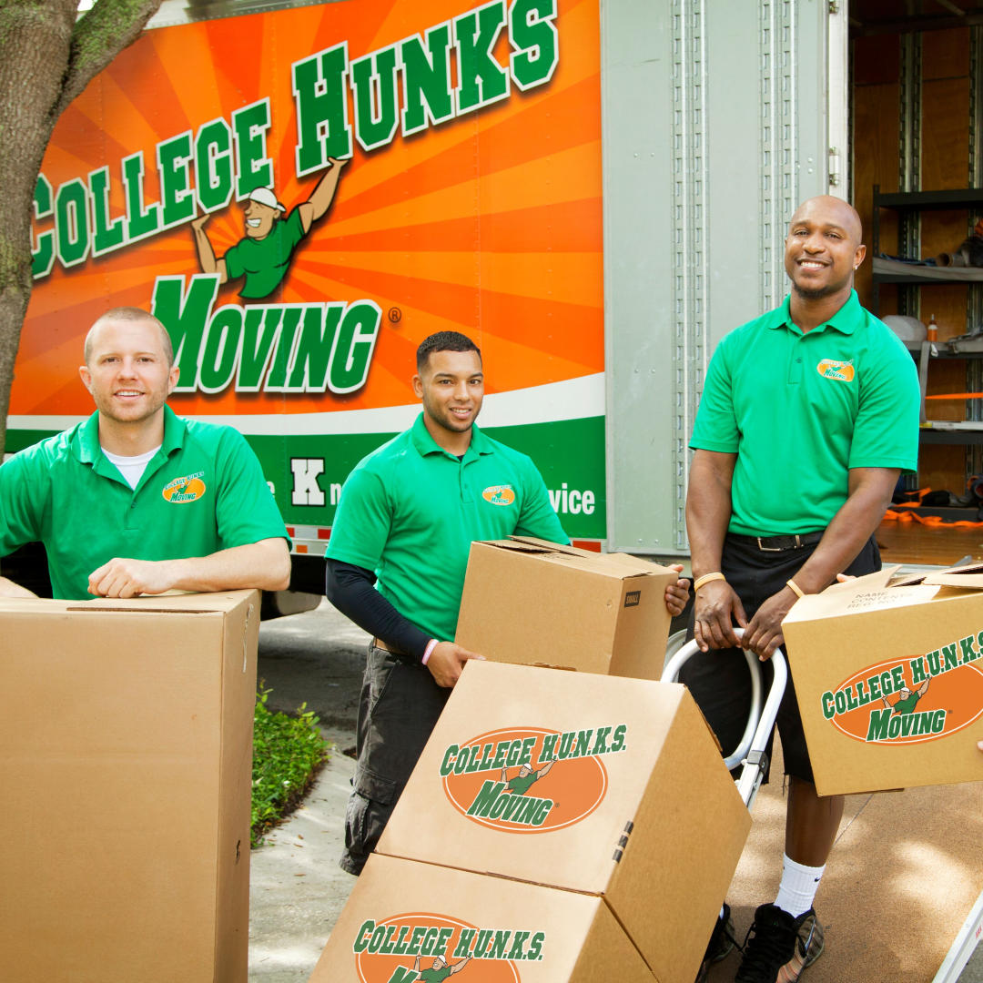 Moving crew unloading box truck from College HUNKS Hauling Junk and Moving