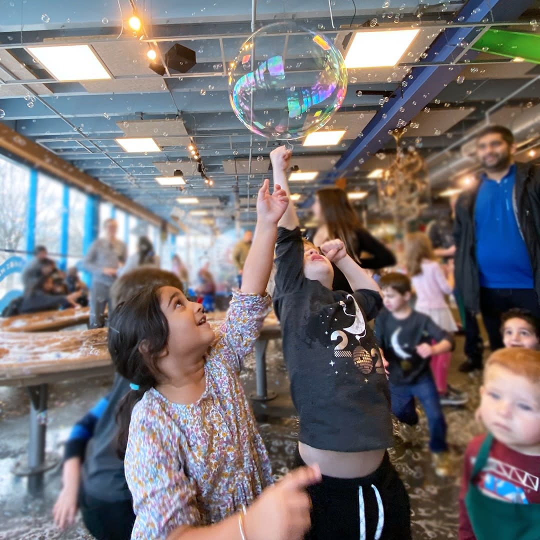 children popping bubbles