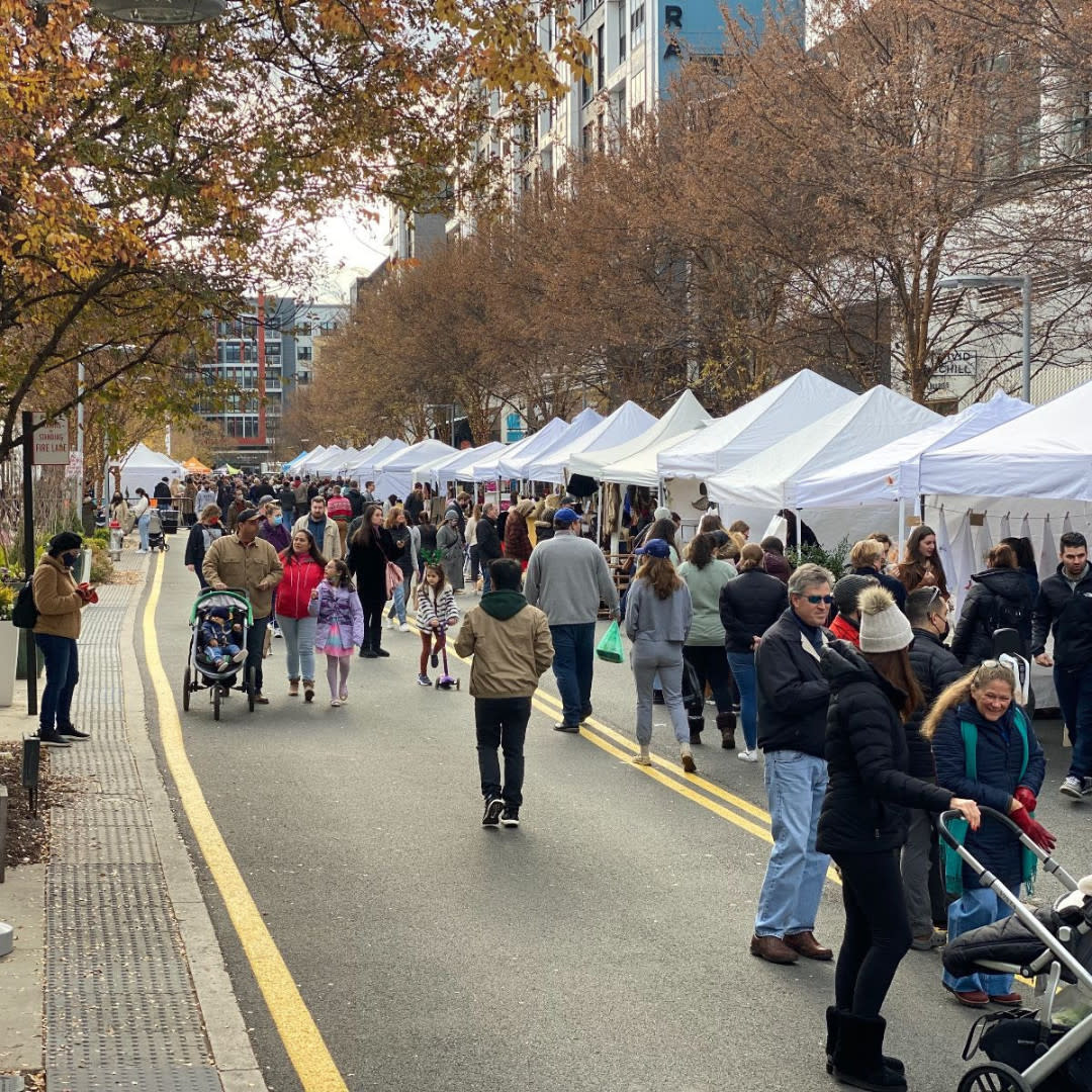 Farmers market with a crowd of people shopping