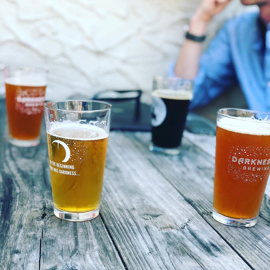 picture of four glasses of beer on a picnic table at darkness brewing in bellevue kentucky