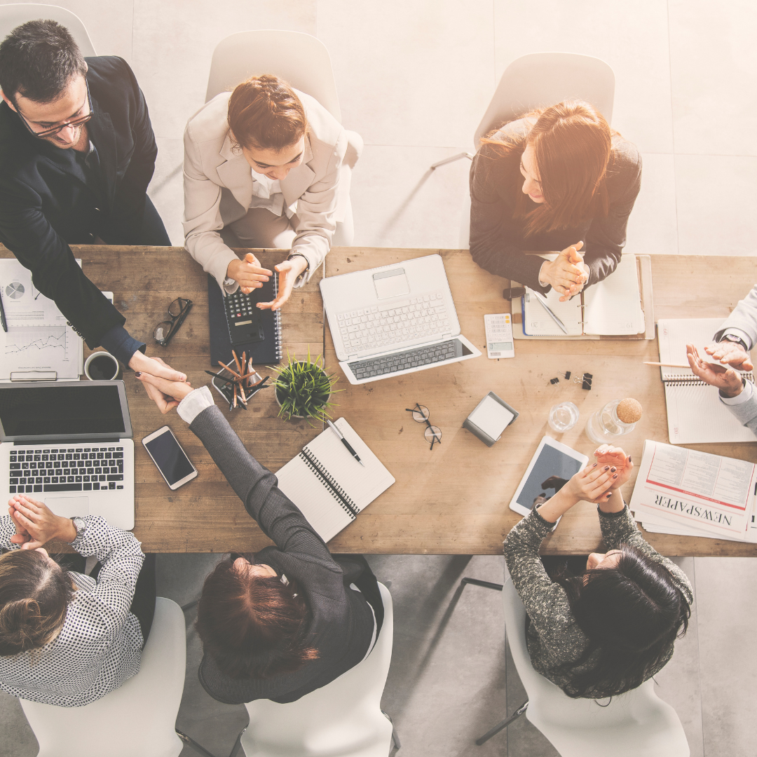 Team working together at a table - stock image