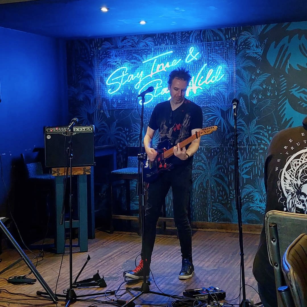 Solo guitarist playing at Grumpy Monkey