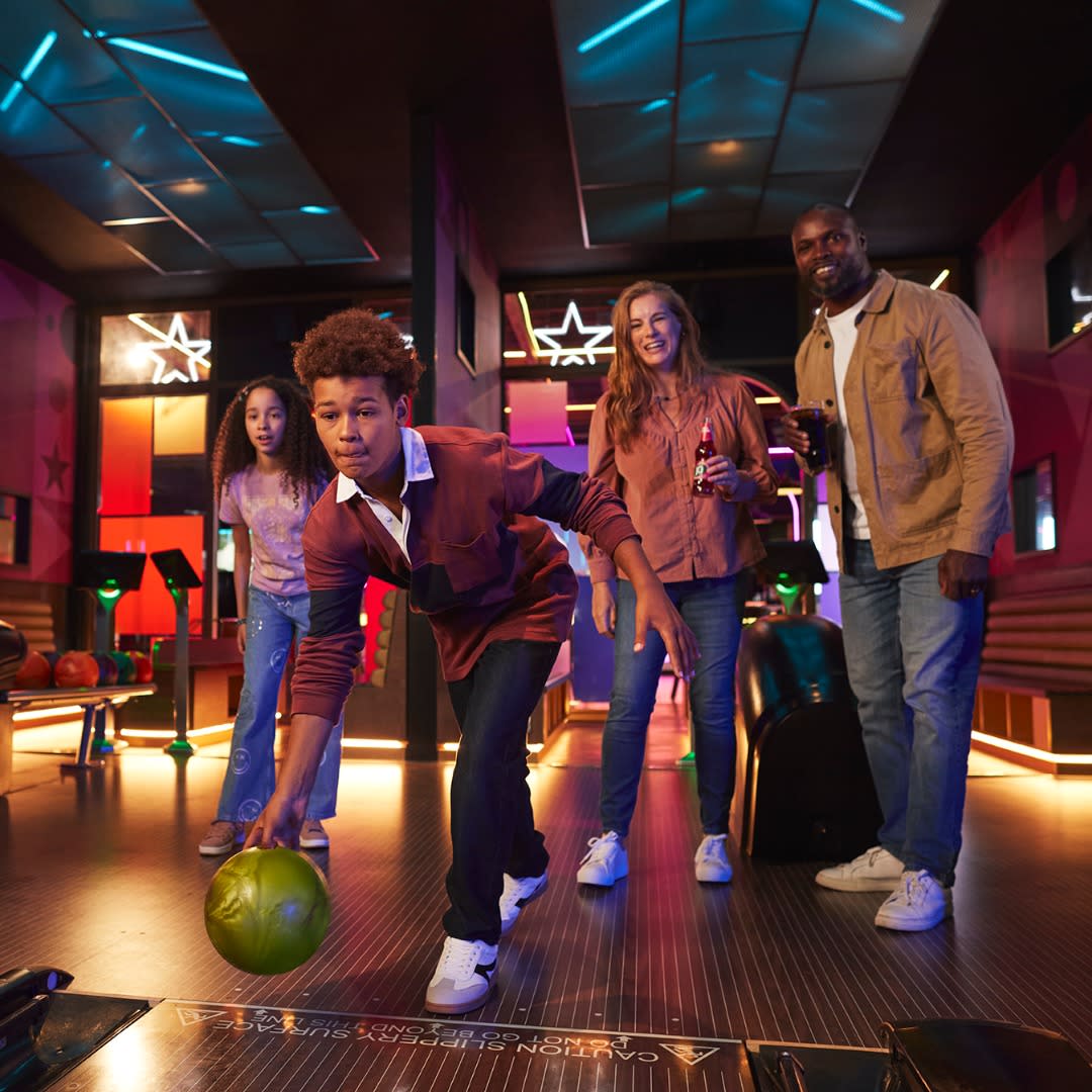 Young family enjoying a game of bowling at Hollywood Bowl