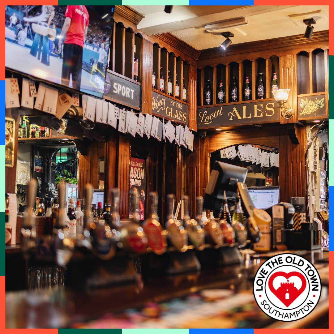 stocked bar inside The Grapes