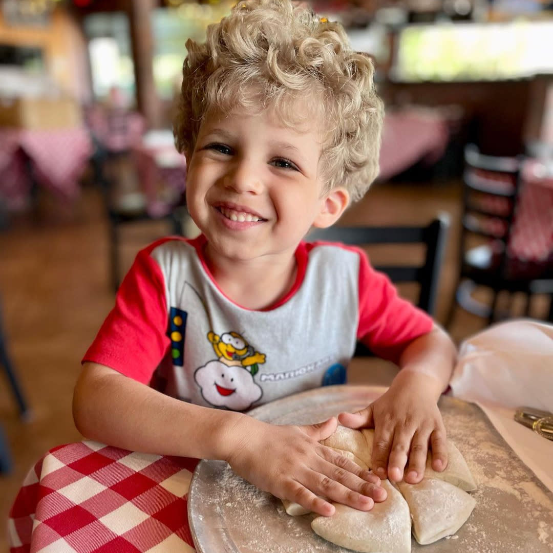 Boy playing with pizza dough at Grimaldi's