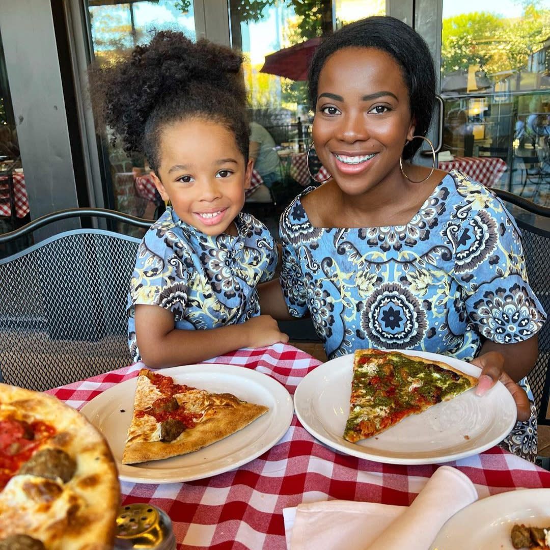Mom and daughter with slices of pizza at Grimaldi's