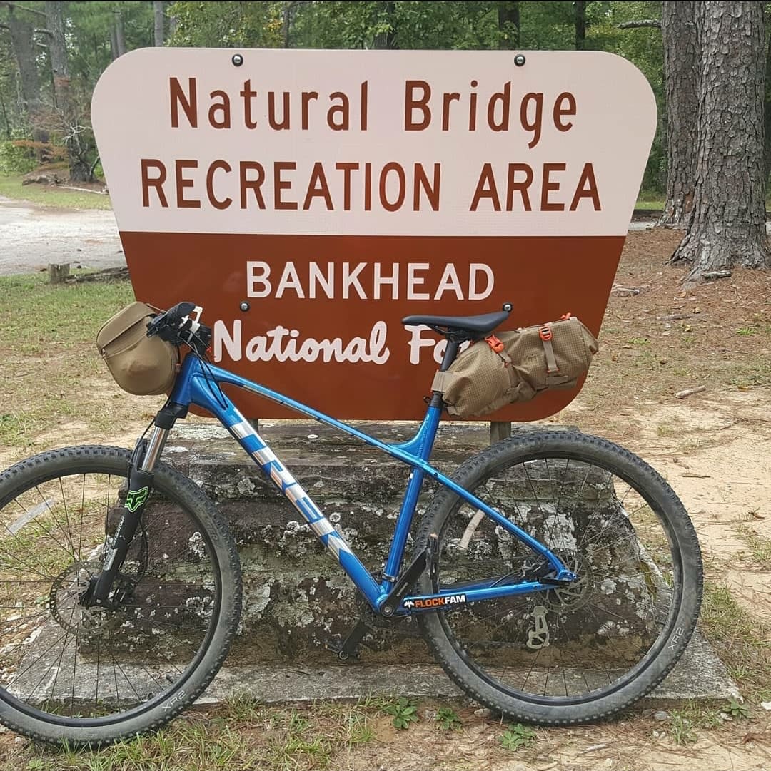 Mountain bike in front of sign for Natural Bridge Recreation Area