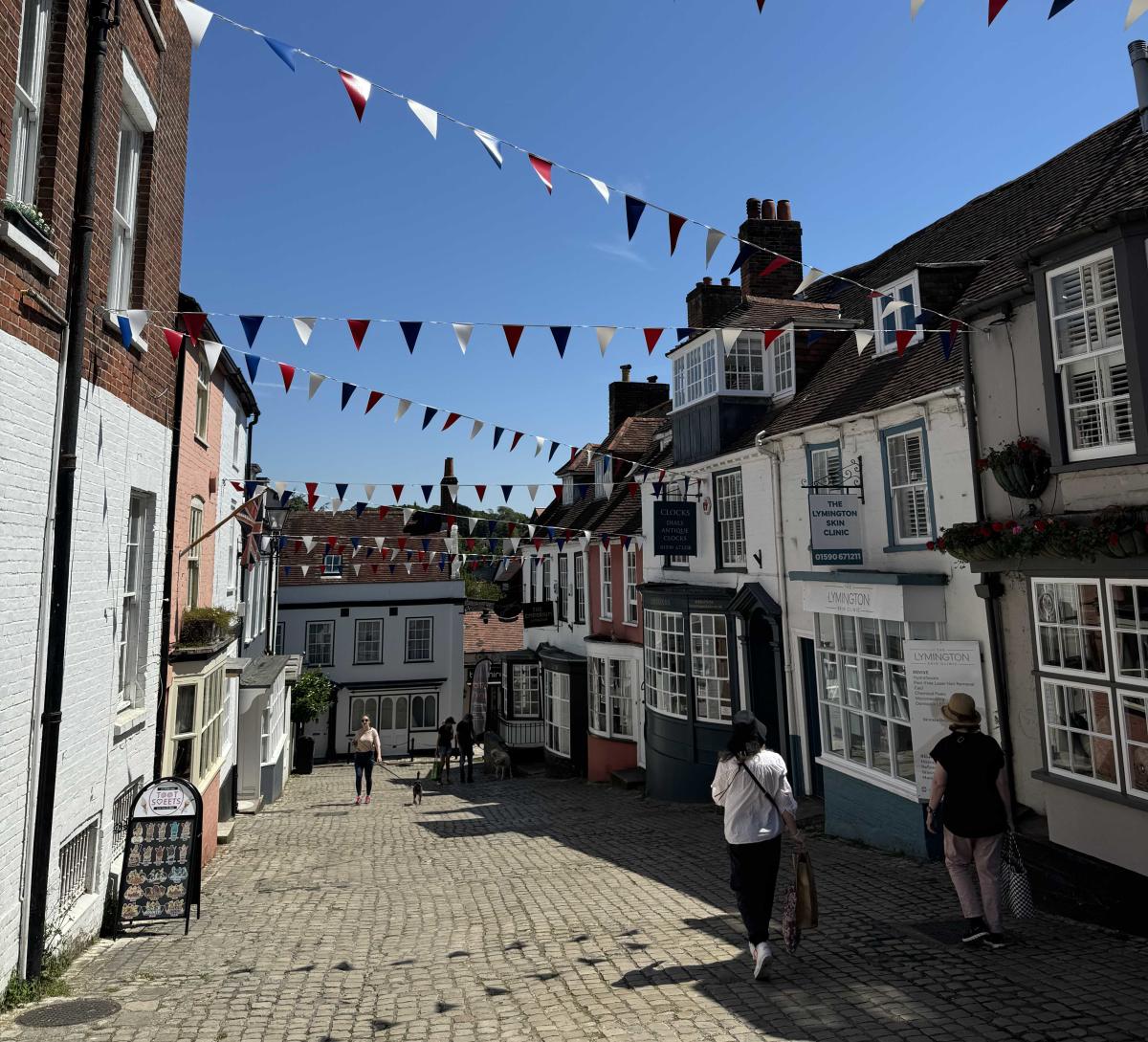 People walking down the cobbled street of Quay Hill in Lymington in the New Forest