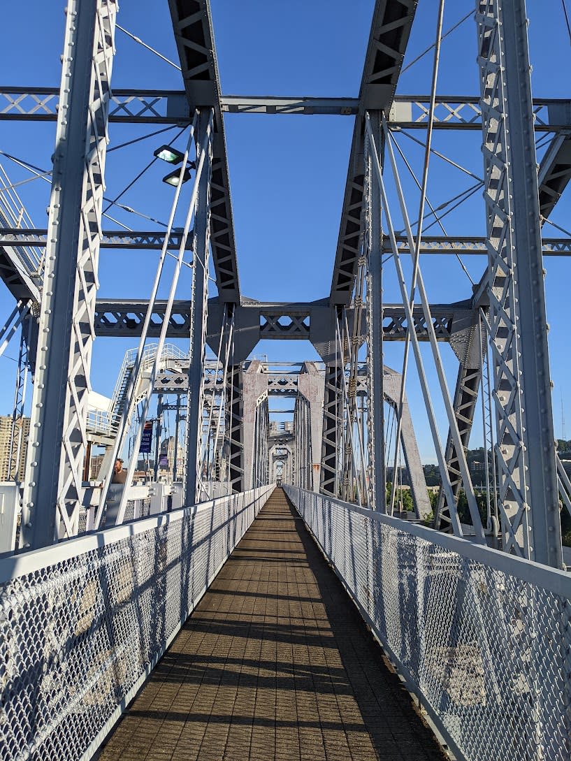 In this image the shot is of the bridge looking from one side of the bridge, straight across to the other. The metal structure is painted purple.