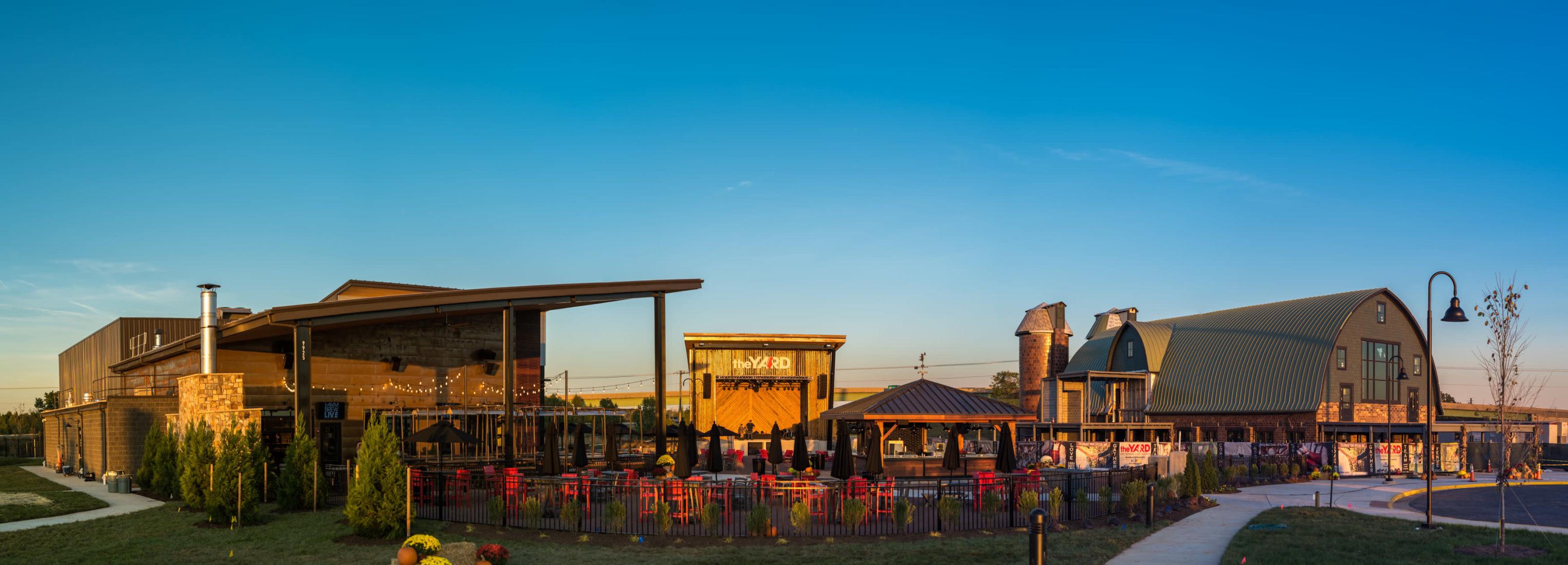 Panoramic of a property in Prince William, there is a pavilion, a stage, a barn as well as a patio