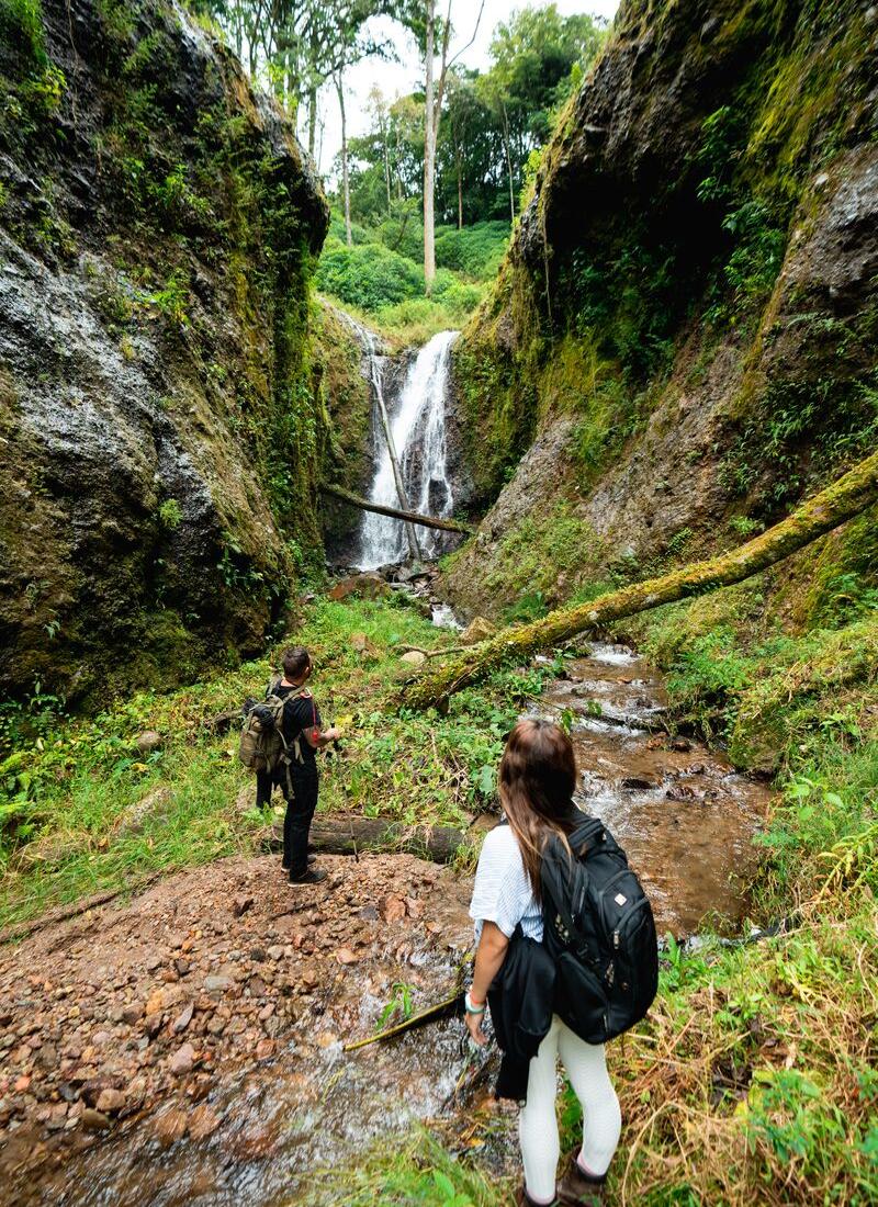 Hikers in front of a waterfall in La Amistad International Park in Chiriquí
