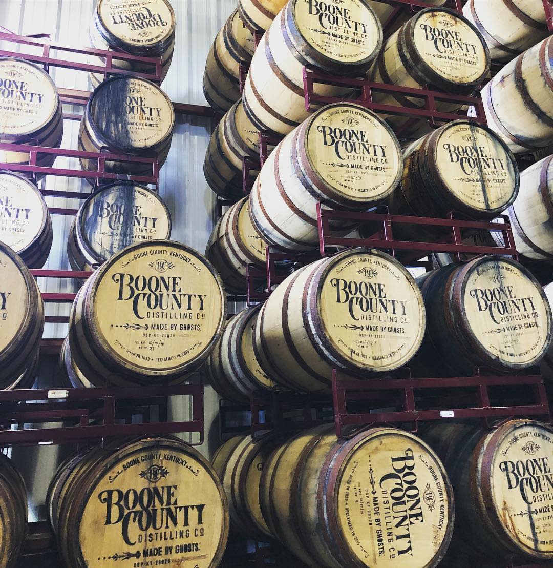 racks of boone county distilling co. bourbon barrels, stamped with their logo