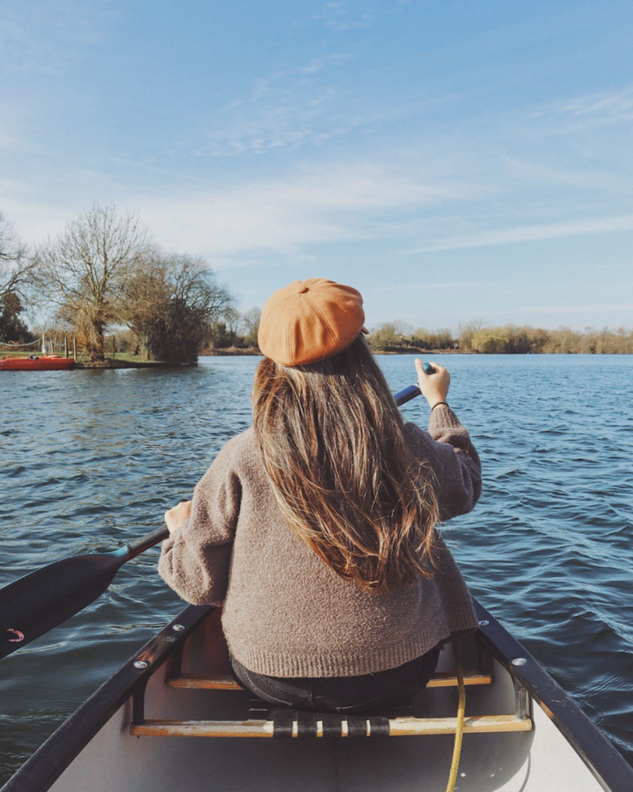 Steph at the front of a tandem canoe on the Cotswold Lakes with The Outdoor Xperience