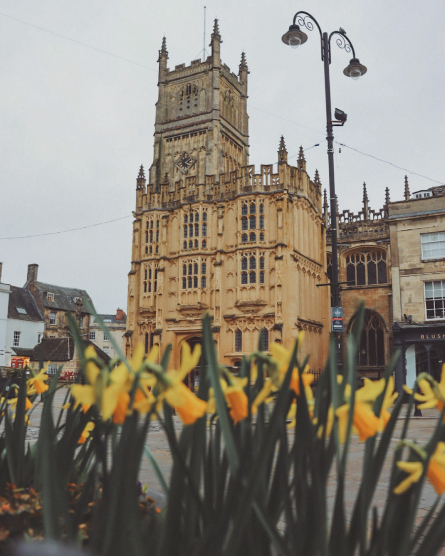 St.John the Baptist church in Cirencester with daffodils in the foreground