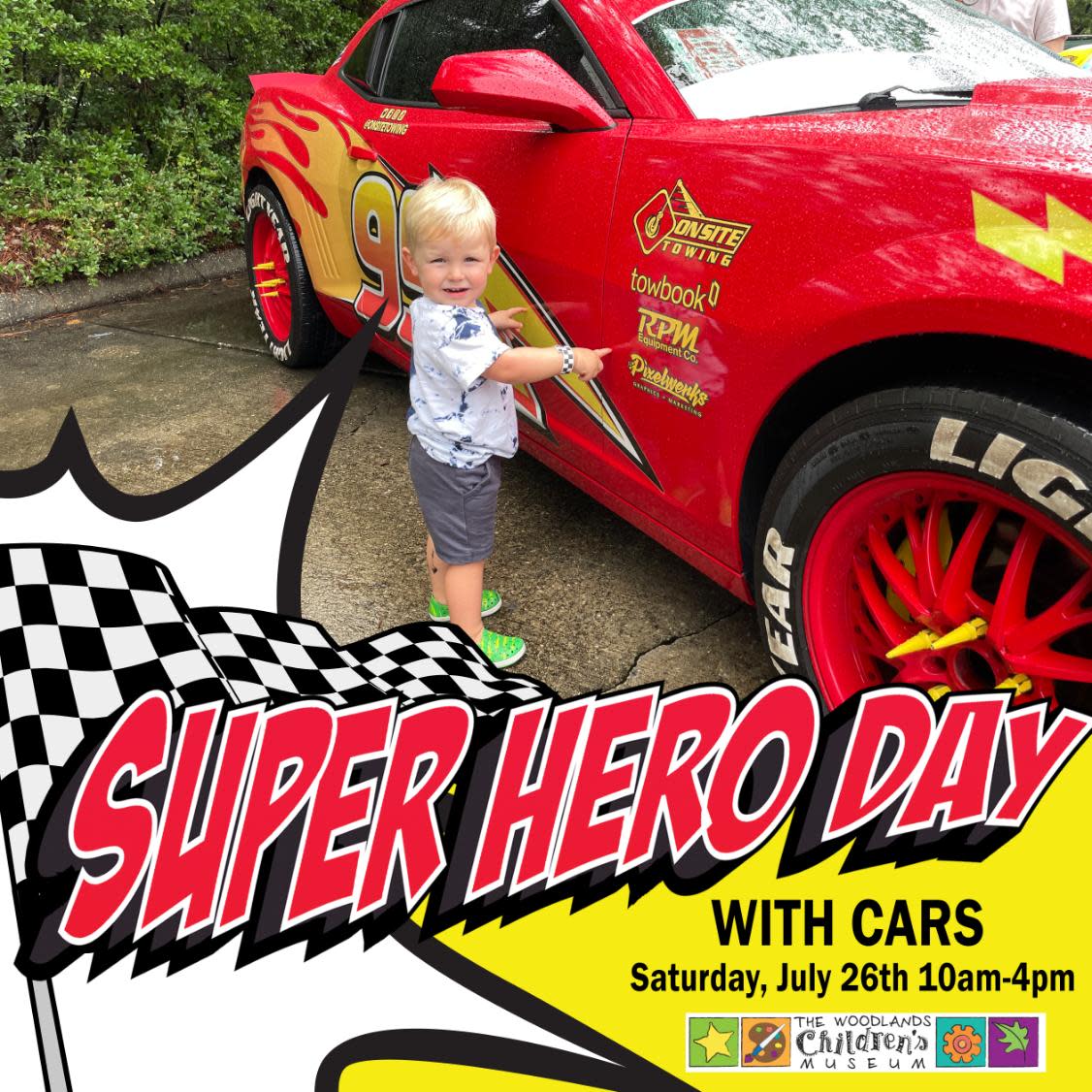 A little boy (maybe 2-3 years old) looks at the camera while pointing to a life-sized model of Lightning McQueen from Disney Pixar's "Cars." Overlaying the lower third of the image is a bright yellow band with a white "spark" (like those that appear in comics or cartoons when a superhero punches a villain) and bold red text that reads, "SUPERHERO DAY WITH CARS | Saturday, July 26th 10am-4pm."