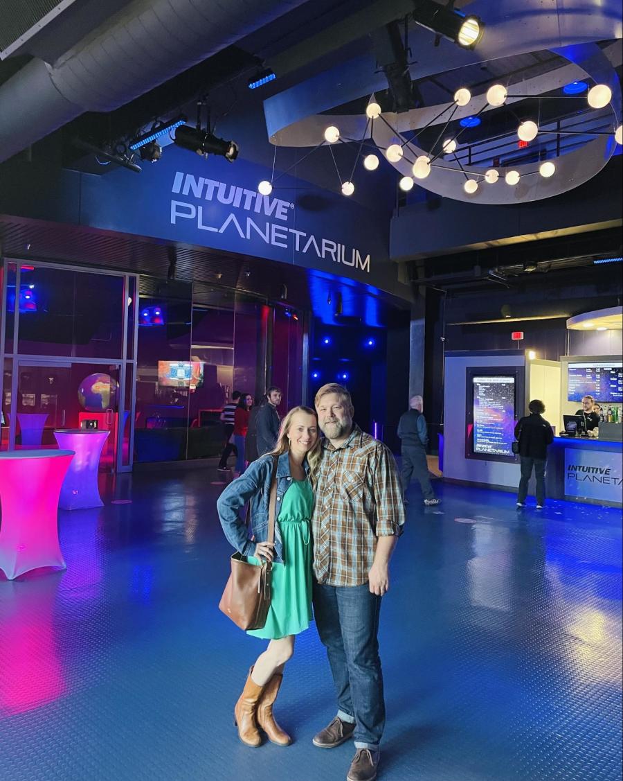 A couple in front of the INTUITIVE Planetarium at the US Space and Rocket Center