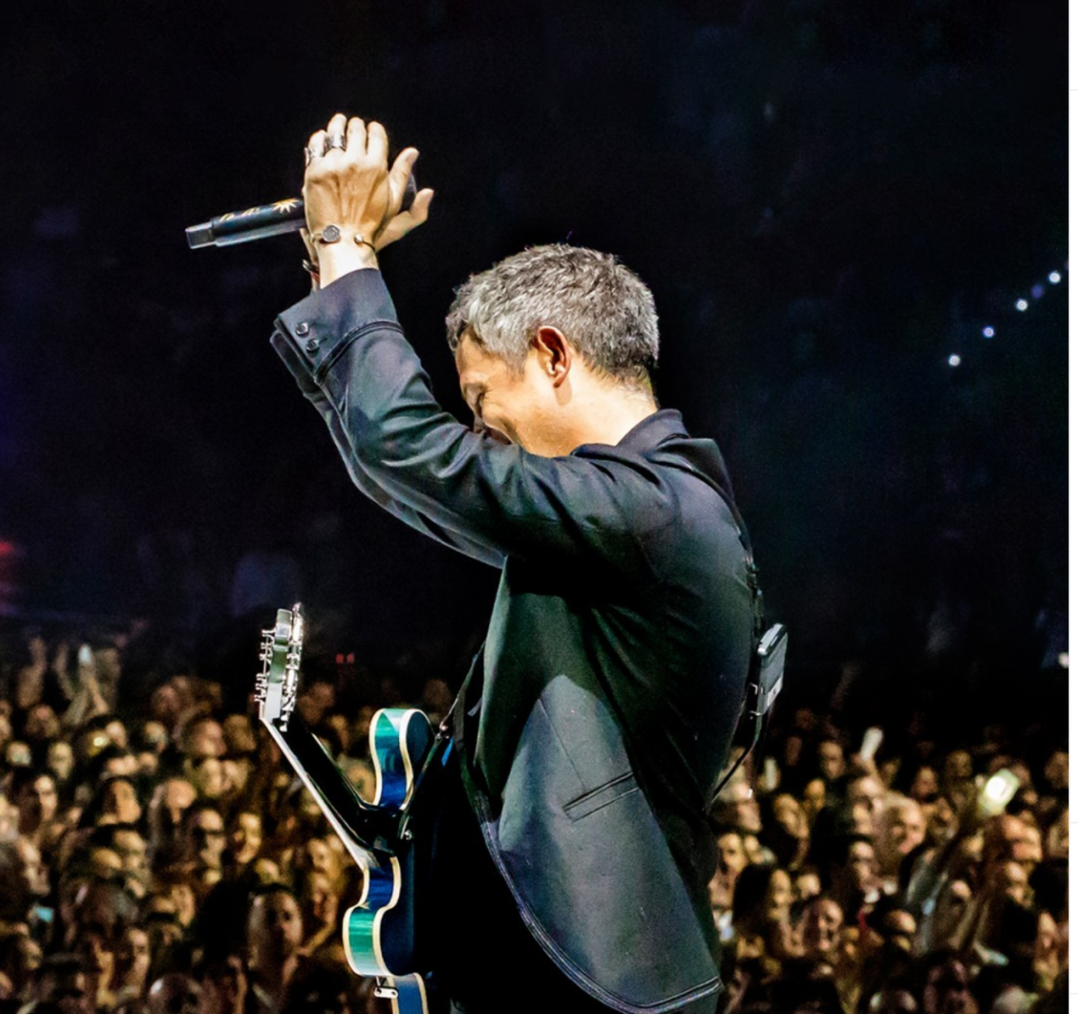 Man With Guitar Waving To Crowd At The Pavilion In Irving, TX