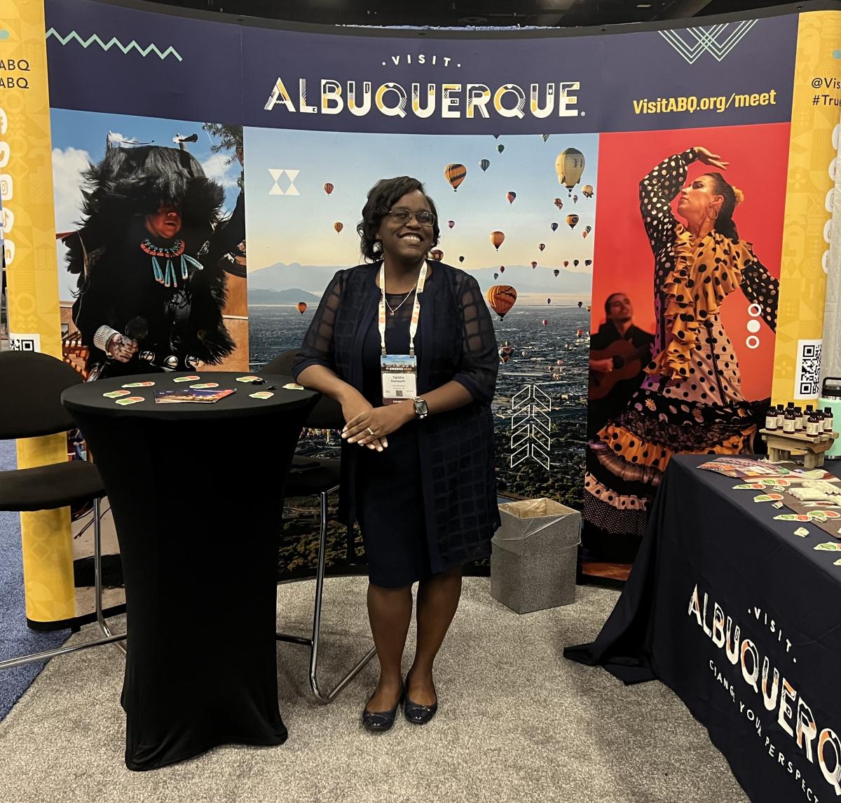 Tabitha Stallworth stands in front of Visit Albuquerque's booth at RCMA's Emerge Conference