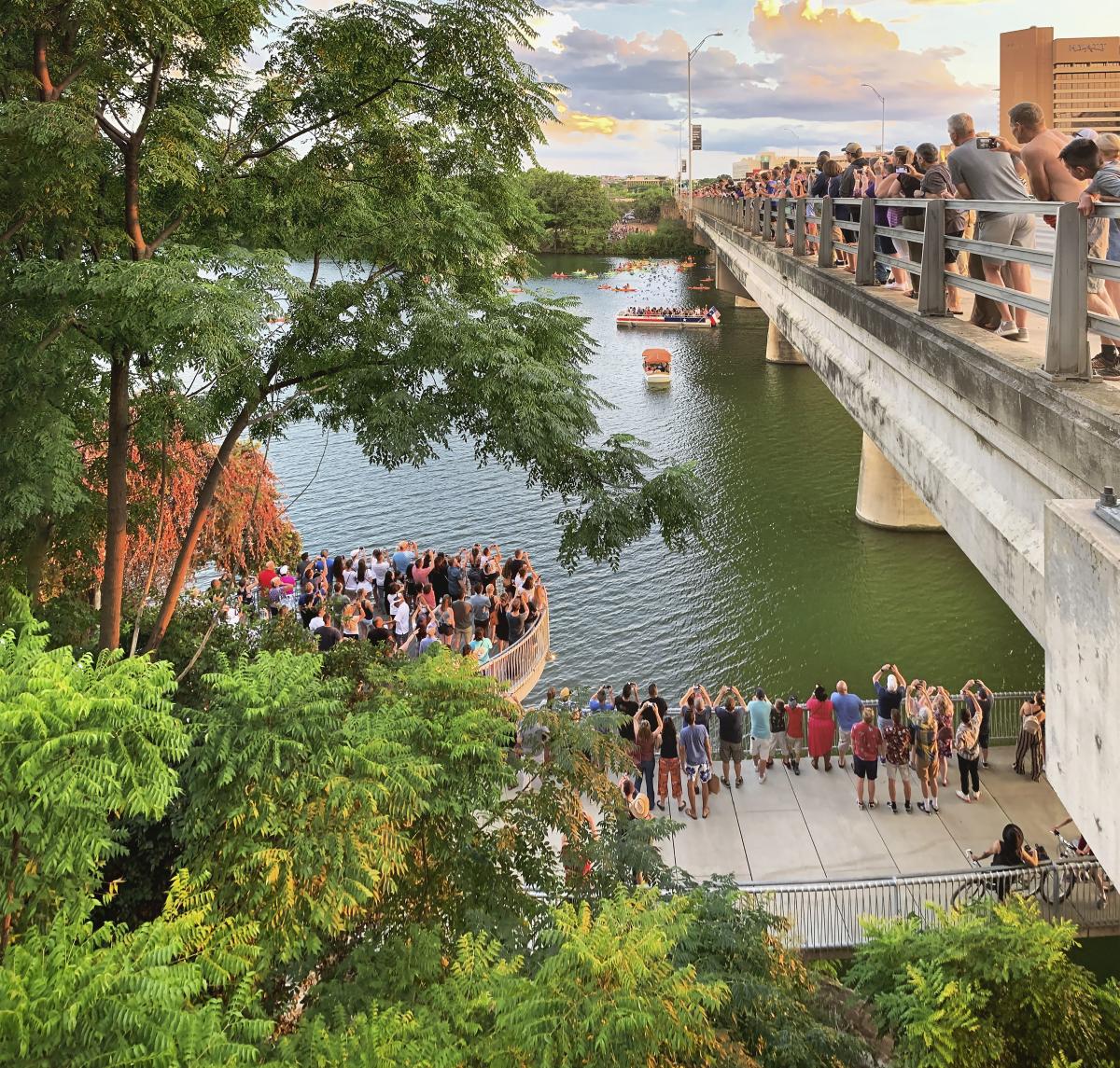 View from north side of Congress Avenue Bridge of crowd along gathering to watch the Austin bats.