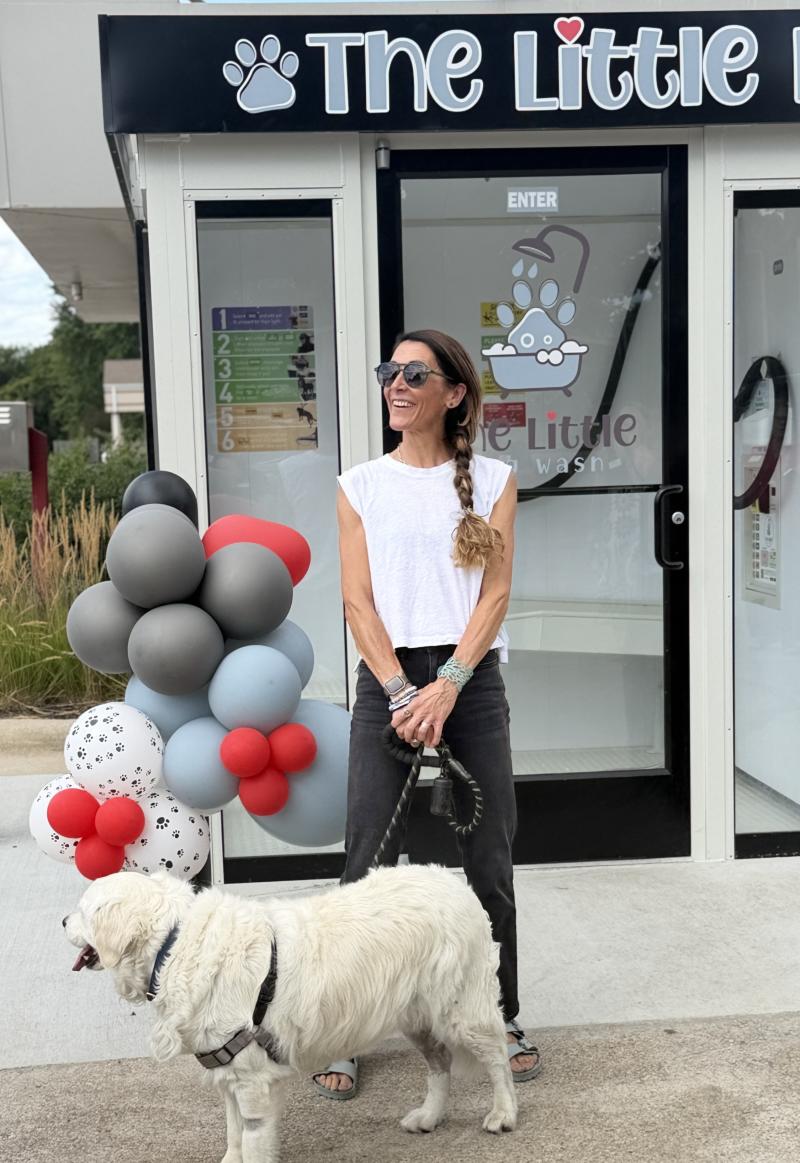 Picture of the owner of The Little Dog Wash in Walworth with her dog outside the dog washing station.
