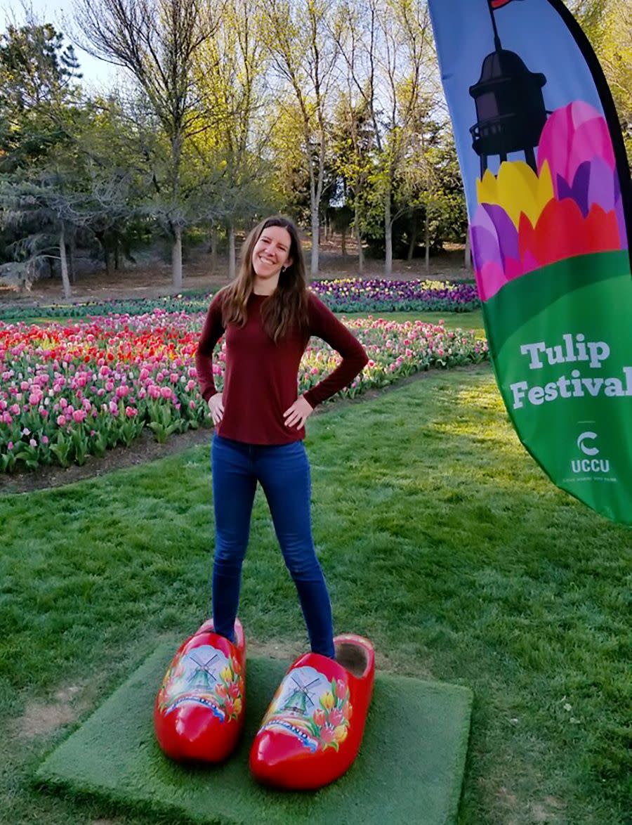 girl stands in comedic oversized Dutch Wooden Clogs