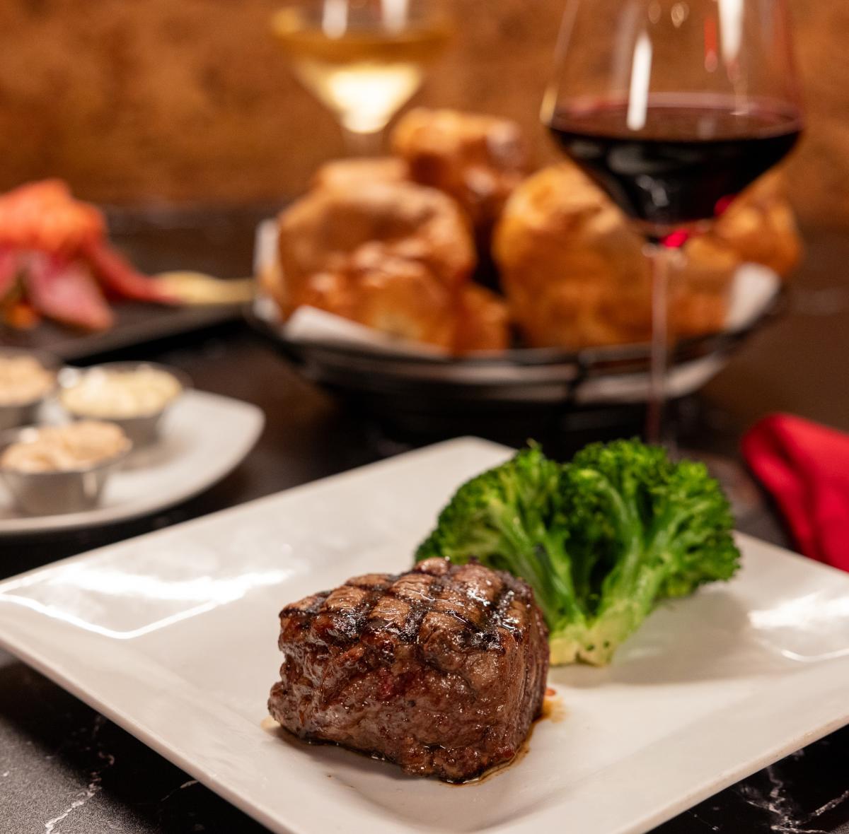 Steak, veggies, popovers, and wine at Prime Serious Steak in Port Charlotte, Florida.