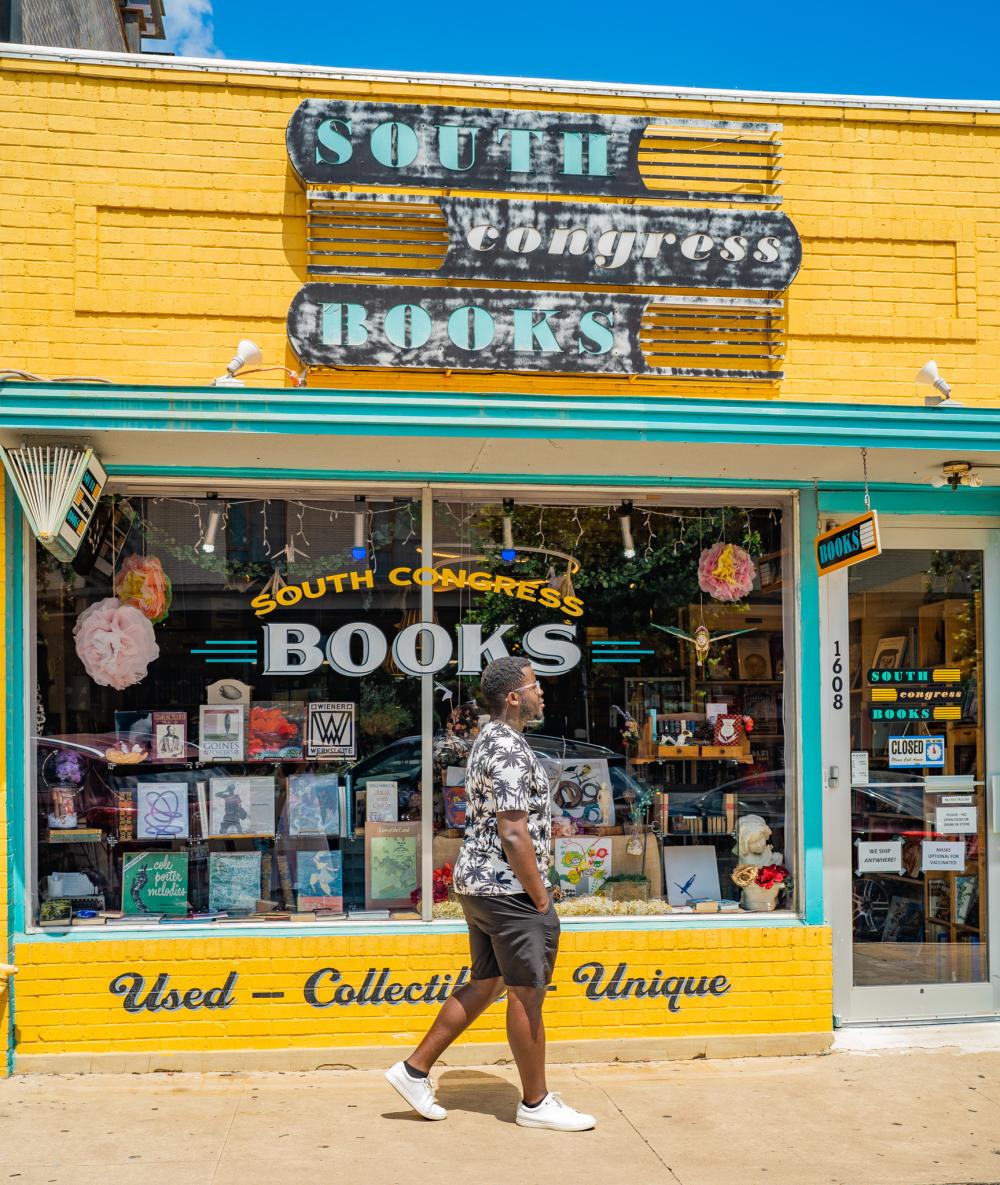 Man walking past the South Congress Books store.