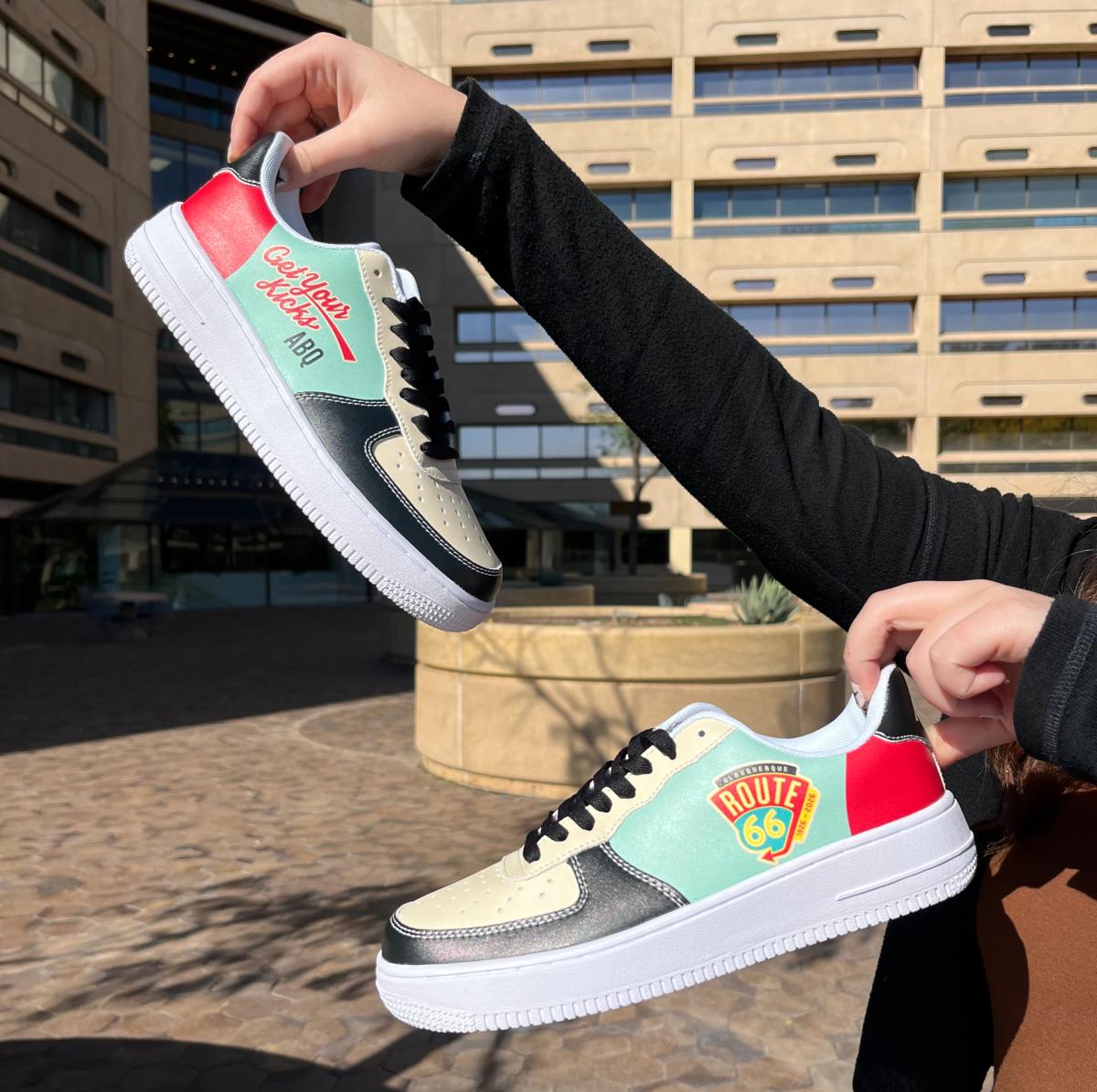 A photo of someone holding two Route 66 custom sneakers.