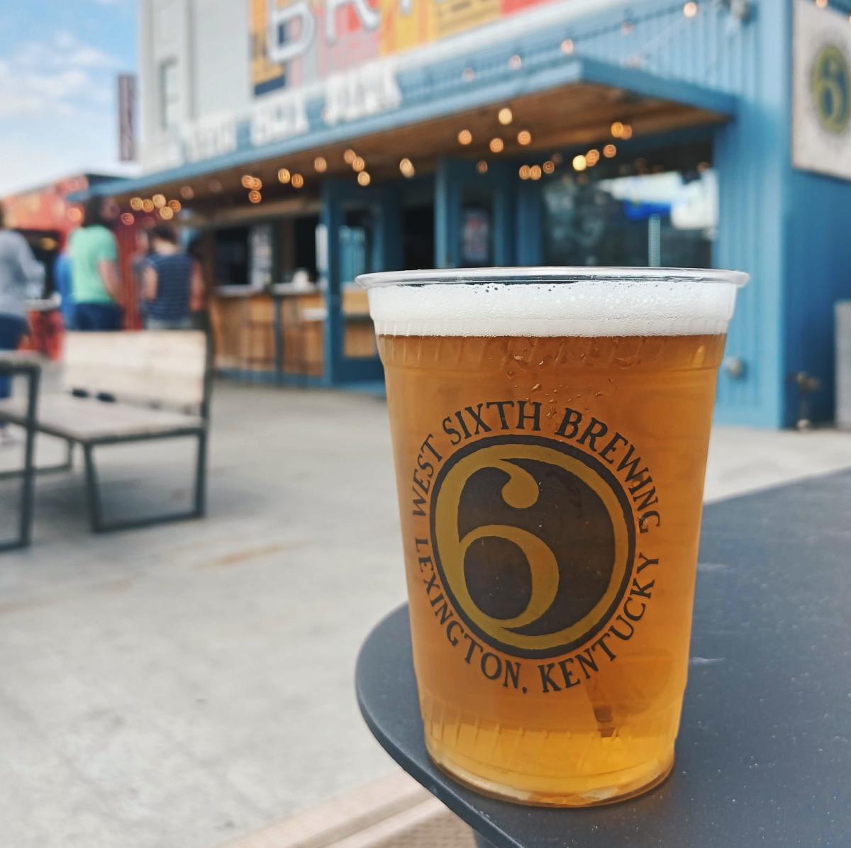 A plastic cup full of beer at the West Sixth Box park at Newport on the Levee