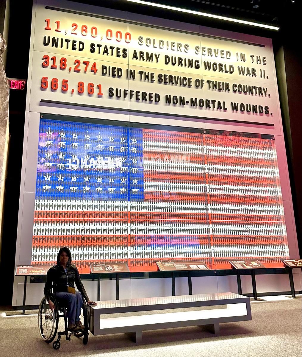 Wheelchair user in front of American flag representing soldier statistics from World War II